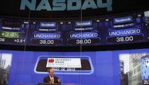 Wicks, Vice President of NASDAQ OMX, stands under monitors showing value of Facebook, Inc. stock before closing bell at NASDAQ Marketsite in New York